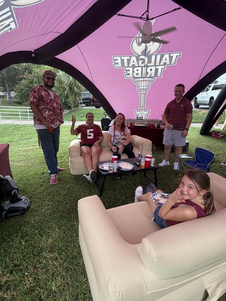 Friends on the inflatable sofas under the tent